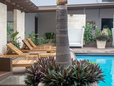 24-	Picture of the pool at the Costa Rica Medical Center Inn, San Jose, Costa Rica.  The picture shows lounge chairs adjacent to the pool.